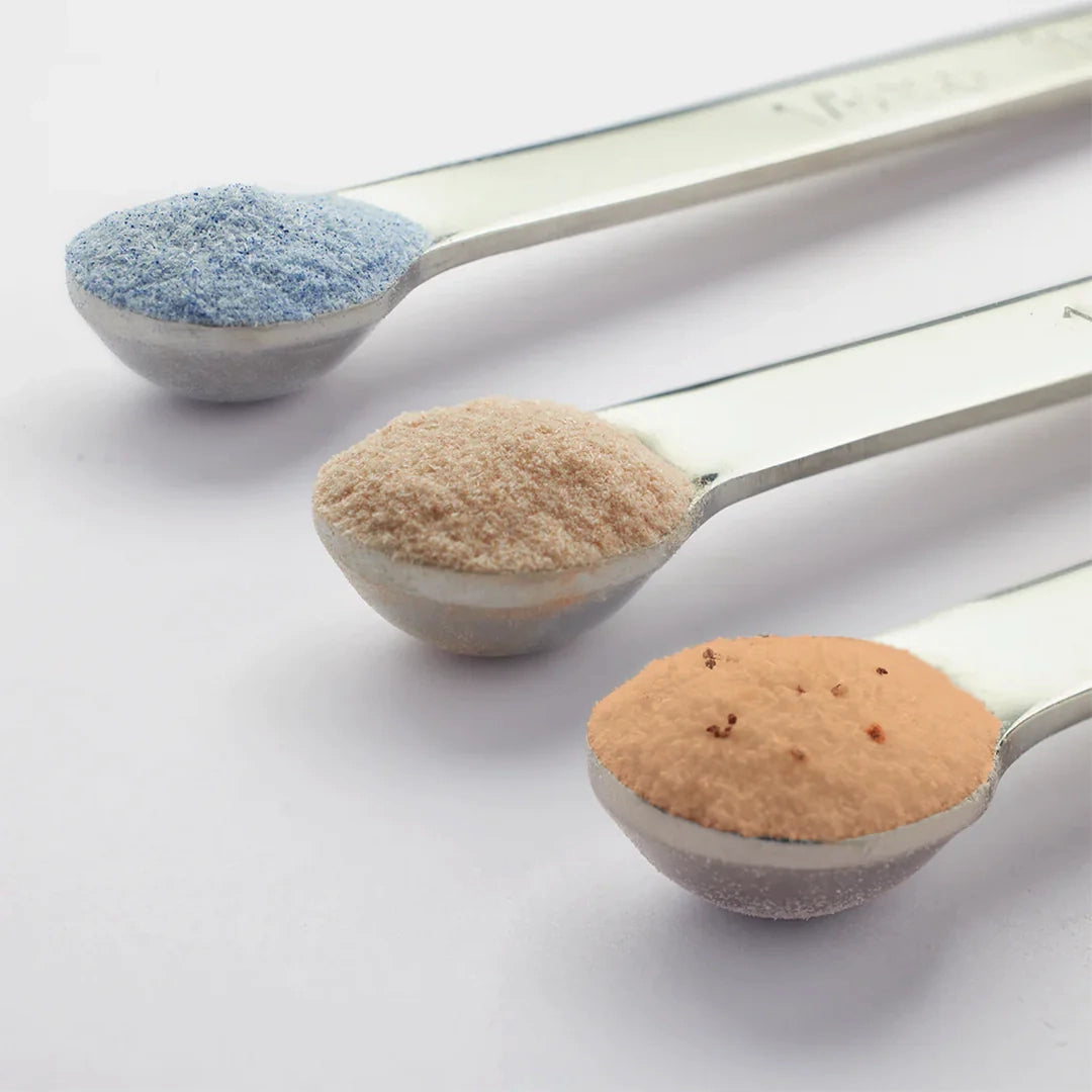 Three scoops of vegan collagen powders - Phycocyanin, Pycnogenol, and Astaxanthin - arranged side by side