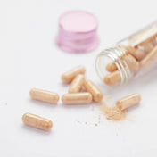 Pycnogenol supplement tablets displayed outside bottle for skin health
