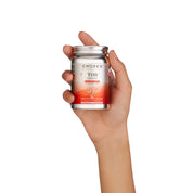 Female hand holding tor coffee collagen tin