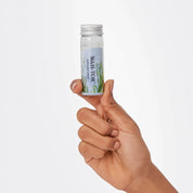 Hand holding a bottle of vegan collagen Phycocyanin supplement